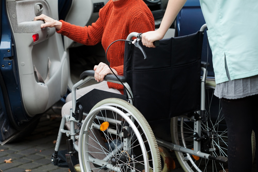 physically impaired person being assisted by woman