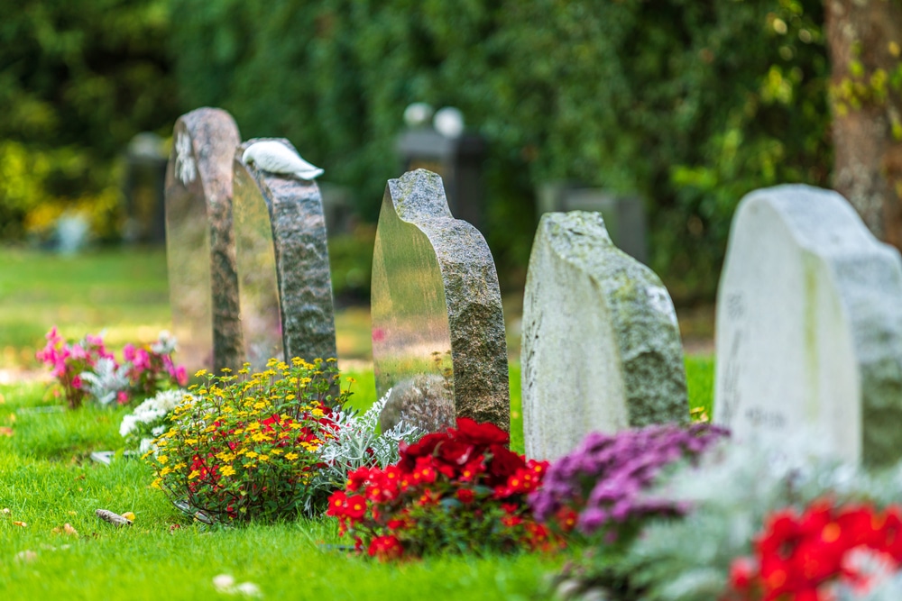 Decorating soldier's grave stones with flowers for Memorial Day