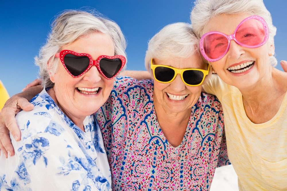 Senior women wearing sunglasses for skin protection.