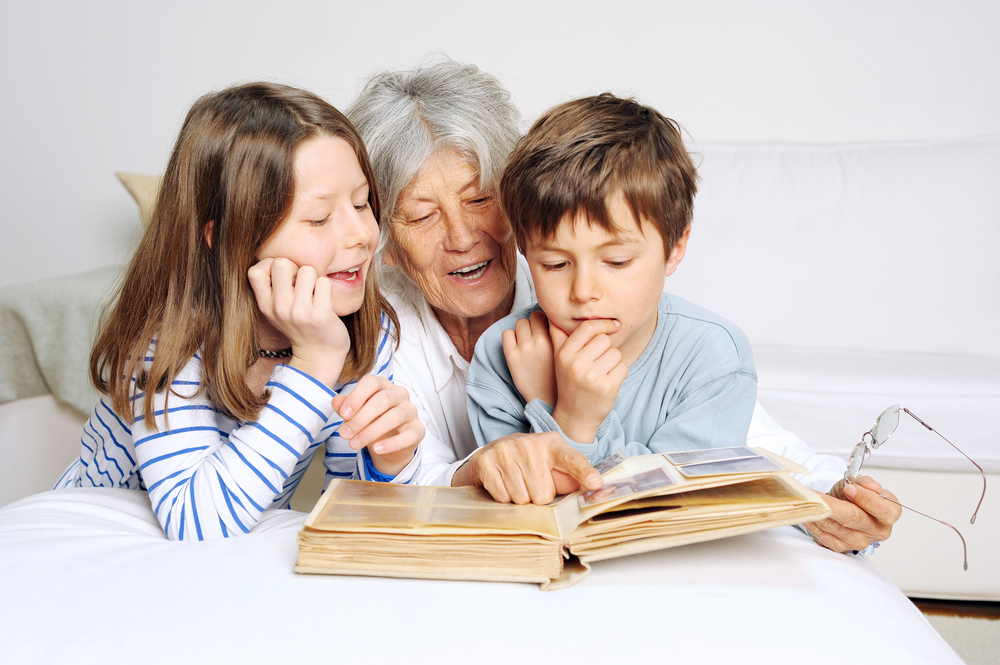 Looking at a family photo album on National Senior Citizens Day