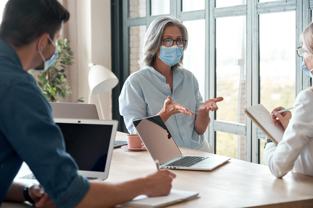 Older female mentor working with people with invisible disabilities